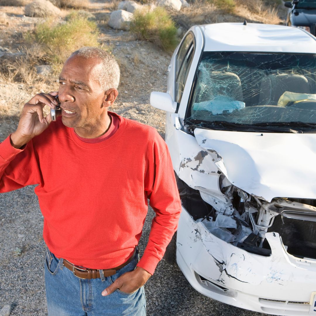 Man on phone after car crash
