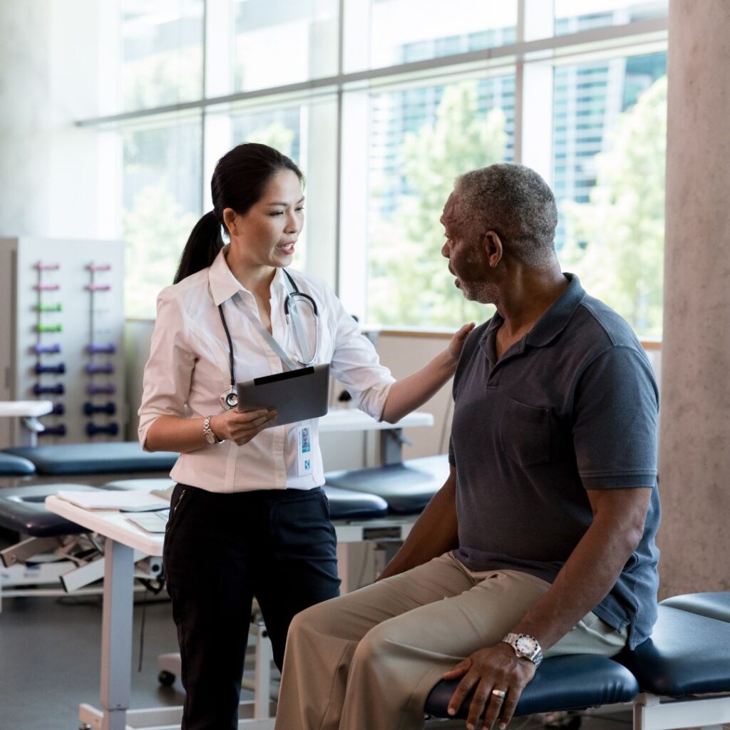 a physical therapist talking with a patient