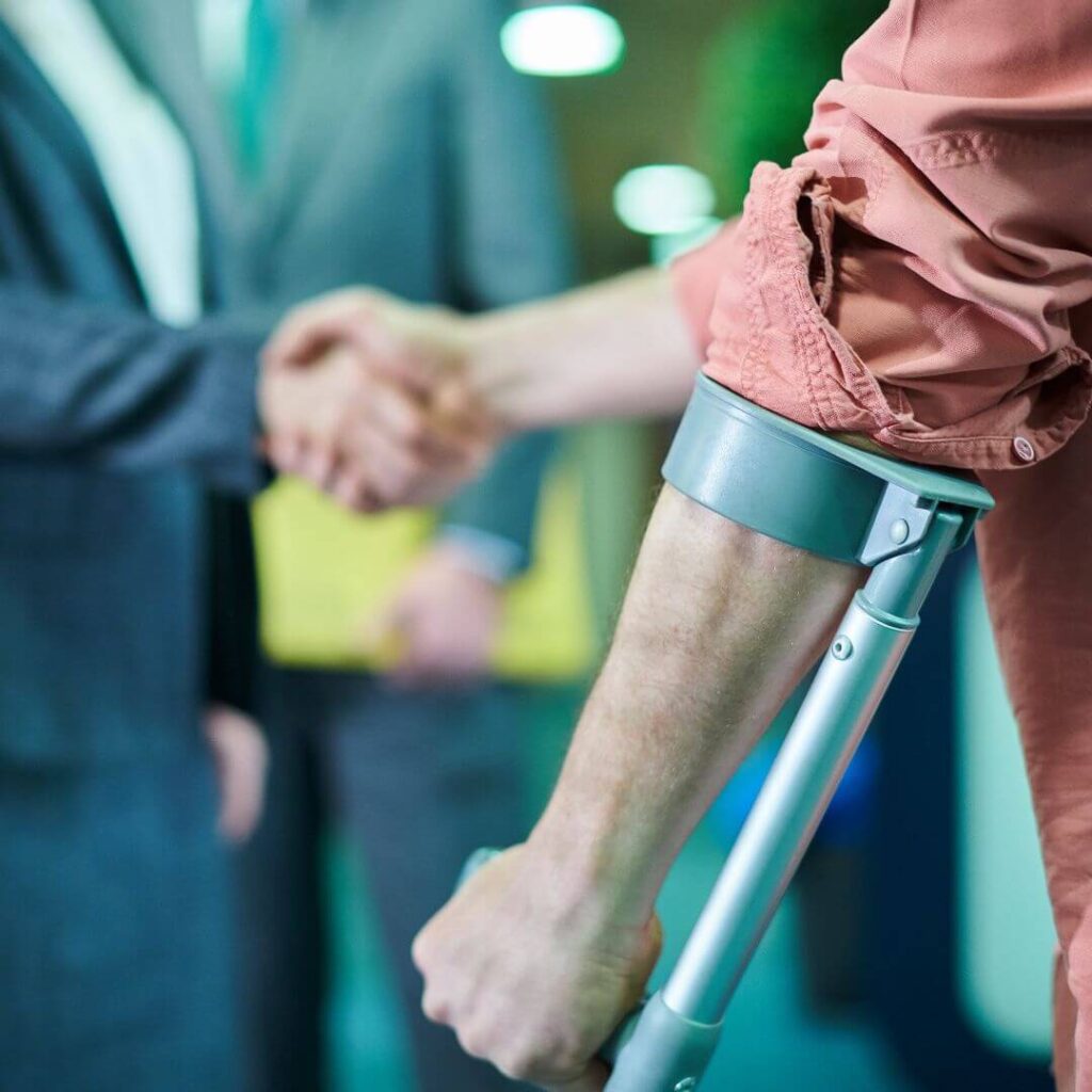 an injured client shaking hands with a lawyer