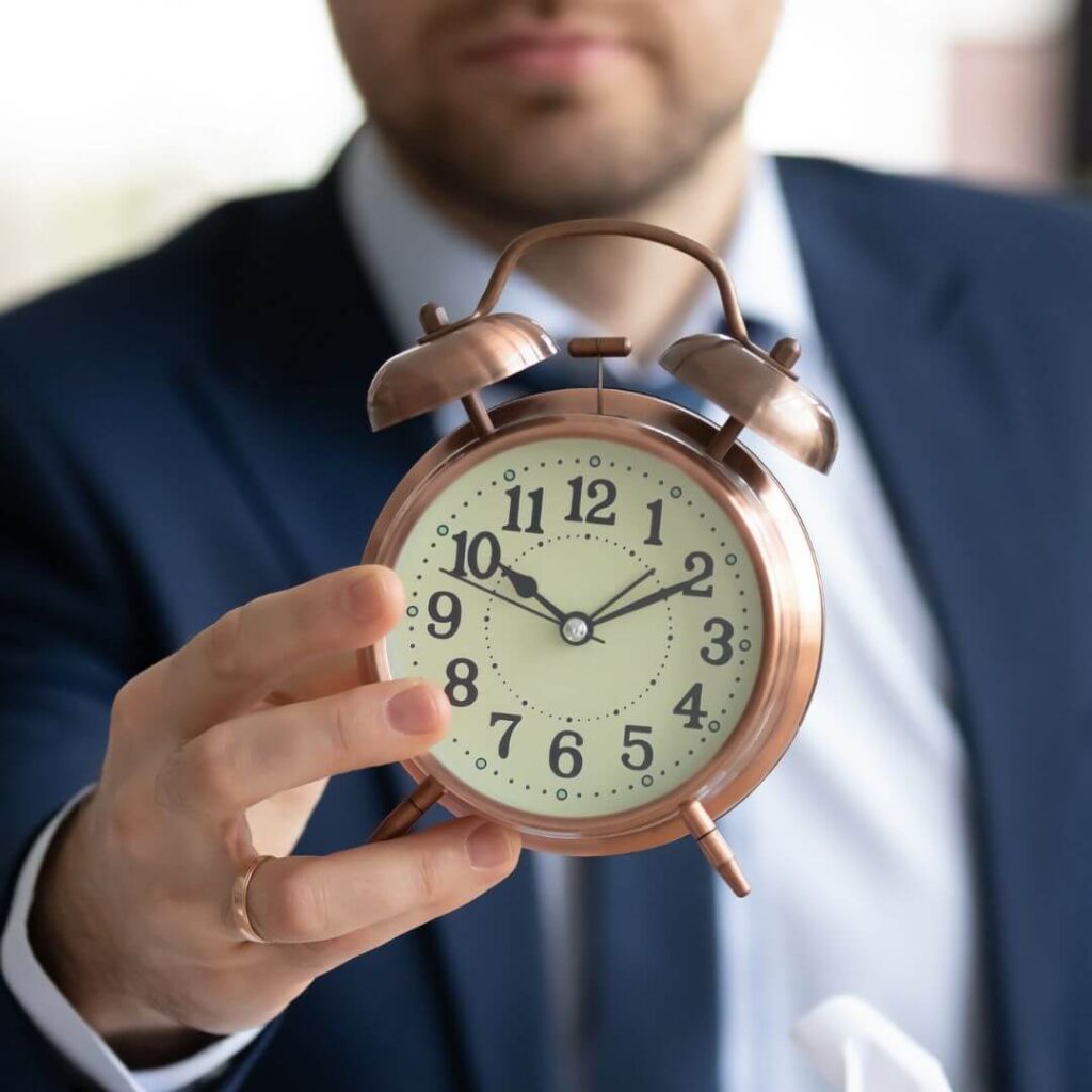 a man holding a clock